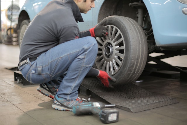 Mechanic fixing car tire alignment